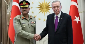 Field Marshal Syed Asim Munir receiving a guard of honour at a military headquarters.