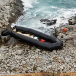 Overcrowded migrant boat at sea near Greek island Lesbos during coast guard rescue operations