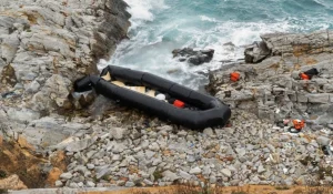 Overcrowded migrant boat at sea near Greek island Lesbos during coast guard rescue operations