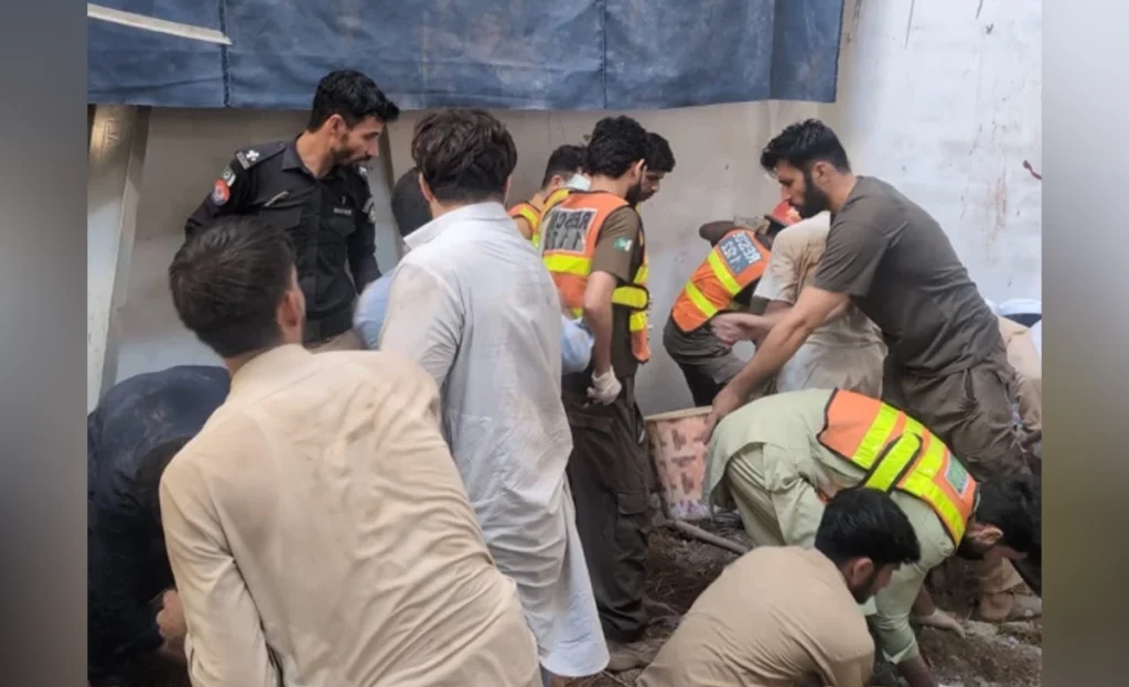 Rescue 1122 and disaster response teams clearing debris at the school roof collapse site in Peshawar
