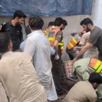Rescue 1122 and disaster response teams clearing debris at the school roof collapse site in Peshawar